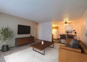 Thumbnail 1 of 10 - a living room with a couch and a coffee table. Fargo, ND Chestnut Ridge Apartments