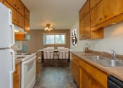 Thumbnail 6 of 42 - the kitchen and dining area of a rental house. Fargo, ND Country Club Apartments.