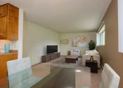 Thumbnail 5 of 42 - a living room with a glass table and a couch and a tv. Fargo, ND Country Club Apartments.