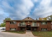 Thumbnail 41 of 42 - an apartment building with two balconies and a sidewalk. Fargo, ND Country Club Apartments.