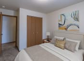 Thumbnail 3 of 44 - a bedroom with a bed and a door to a closet. Fargo, ND Country Edge Apartments