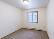 Thumbnail 12 of 44 - a spacious bedroom with carpet and a window. Fargo, ND Country Edge Apartments