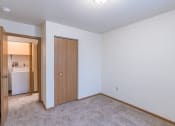 Thumbnail 13 of 44 - a bedroom with a door to a hallway. Fargo, ND Country Edge Apartments
