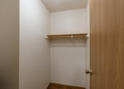 Thumbnail 17 of 44 - an empty closet in a room with a wooden door. Fargo, ND Country Edge Apartments