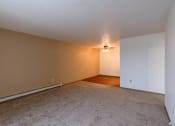 Thumbnail 7 of 44 - the living room and dining room of an empty apartment. Fargo, ND Country Edge Apartments