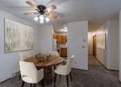 Thumbnail 3 of 16 - a dining room with a table and chairs and a ceiling fan. Fargo, ND Crescent Park Apartments