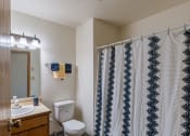 Thumbnail 14 of 16 - a bathroom with a shower and a toilet and a sink. Fargo, ND Crescent Park Apartments