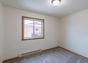 Thumbnail 11 of 16 - the living room of an empty house with a large window.Fargo, ND Crescent Park Apartments
