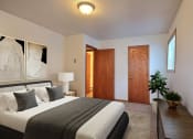 Thumbnail 4 of 10 - Fargo, ND Dakota Manor Apartments. a bedroom with a bed and a desk in a room