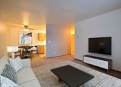 Thumbnail 1 of 10 - Fargo, ND Dakota Manor Apartments. a living room with a couch and a coffee table