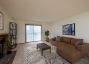 Thumbnail 1 of 12 - Fargo, ND Dynasty Apartments a living room with a couch coffee table and fireplace