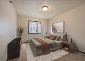 Thumbnail 2 of 28 - the view of a bedroom with a bed and a window. Fargo, ND Eagle Run Apartments