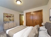 Thumbnail 5 of 12 - a bedroom with a bed and a dresser. Fargo, ND Emerald Apartments