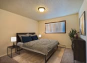 Thumbnail 4 of 12 - a bedroom with a bed and a window. Fargo, ND Emerald Apartments