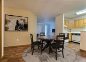 Thumbnail 5 of 23 - Fargo, ND Flagstone Apartments. a dining area with a table and chairs and a kitchen in the background