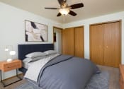 Thumbnail 6 of 18 - Fargo, ND Flickertail Apartments a bedroom with a bed and a ceiling fan