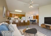 Thumbnail 2 of 18 - Fargo, ND Flickertail Apartments a living room with a couch and a table in front of a tv