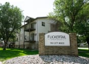 Thumbnail 17 of 18 - Fargo, ND Flickertail Apartments. Exterior of an apartment building with a sign that says Flickertail outside.