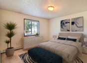 Thumbnail 5 of 19 - Fargo, ND Foxboro Townhomes. a bedroom with a large bed and a window