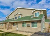Thumbnail 15 of 15 - a house with a green roof and a sidewalk. Fargo, ND Foxtail Townhomes