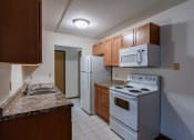 Thumbnail 20 of 25 - a kitchen with white tile flooring and white appliances at France, North Dakota, 58103
