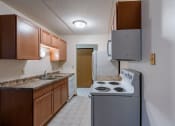 Thumbnail 19 of 25 - a kitchen with white tile flooring, white appliances at France, North Dakota