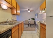 Thumbnail 4 of 25 - a kitchen with wooden cabinets and a dining room in the background at France, North Dakota, 58103