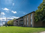 Thumbnail 25 of 25 - a large brick apartment building with a green grass in front at France, North Dakota