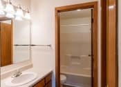 Thumbnail 10 of 19 - a bathroom with a shower and a sink and a mirror. Fargo, ND Galleria 3 Apartments