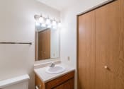 Thumbnail 11 of 19 - a bathroom with a sink and a mirror and a shower. Fargo, ND Galleria 3 Apartments