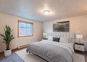Thumbnail 3 of 19 - a bedroom with a bed and a potted plant. Fargo, ND Galleria 3 Apartments