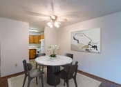 Thumbnail 2 of 19 - a dining room with a table and chairs and a ceiling fan. Fargo, ND Galleria 3 Apartments