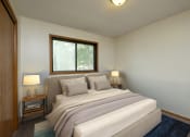 Thumbnail 5 of 9 - Fargo, ND Gemstone Apartments. A bedroom with a bed and two night stands and a window.