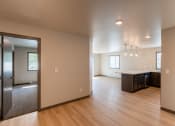 Thumbnail 8 of 24 - An open living room and kitchen and wood floors. Fargo, ND Granger Court Apartments.