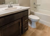 Thumbnail 22 of 24 - A bathroom with sink toilet and shower. Fargo, ND Granger Court Apartments.
