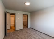 Thumbnail 16 of 24 - A bedroom with a door to a bathroom and a closet. Fargo, ND Granger Court Apartments.