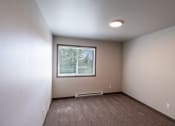 Thumbnail 19 of 24 - A bedroom with a window and baseboard heater. Fargo, ND Granger Court Apartments.