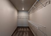 Thumbnail 17 of 24 - a walk in closet with shelves. Fargo, ND Granger Court Apartments.