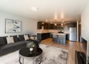 Thumbnail 1 of 24 - a living room with a couch and a table in front of a kitchen. Fargo, ND Granger Court Apartments .