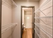 Thumbnail 21 of 24 - A large walk in closet in a home with metal shelves. Fargo, ND Granger Court Apartments.