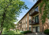 Thumbnail 23 of 24 - Exterior view of a brick apartment building with balconies. Fargo, ND Granger Court Apartments.