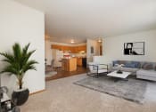 Thumbnail 1 of 9 - Fargo, ND Hunters Run Apartments. A living room with a couch, table, and four chairs and a kitchen in the background.