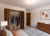 Thumbnail 5 of 13 - a bedroom with a closet and a bed and a dresser. Fargo, ND Huntington Apartments