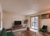 Thumbnail 2 of 13 - a living room with a couch and a table and a tv. Fargo, ND Huntington Apartments