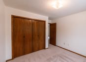 Thumbnail 10 of 13 - A bedroom with a closet. Fargo, ND Huntington Apartments.