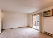 Thumbnail 6 of 13 - an empty living room with a sliding glass door to a balcony