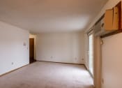 Thumbnail 7 of 13 - A empty living room with white walls and a window. Fargo, ND Huntington Apartments.