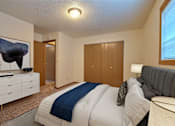 Thumbnail 5 of 20 - a bedroom with a bed and a dresser. Fargo, ND Kennedy Apartments