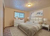 Thumbnail 4 of 20 - a bedroom with a bed and a dresser. Fargo, ND Kennedy Apartments