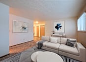 Thumbnail 1 of 20 - a living room with a white couch and a gray and white rug. Fargo, ND Kennedy Apartments